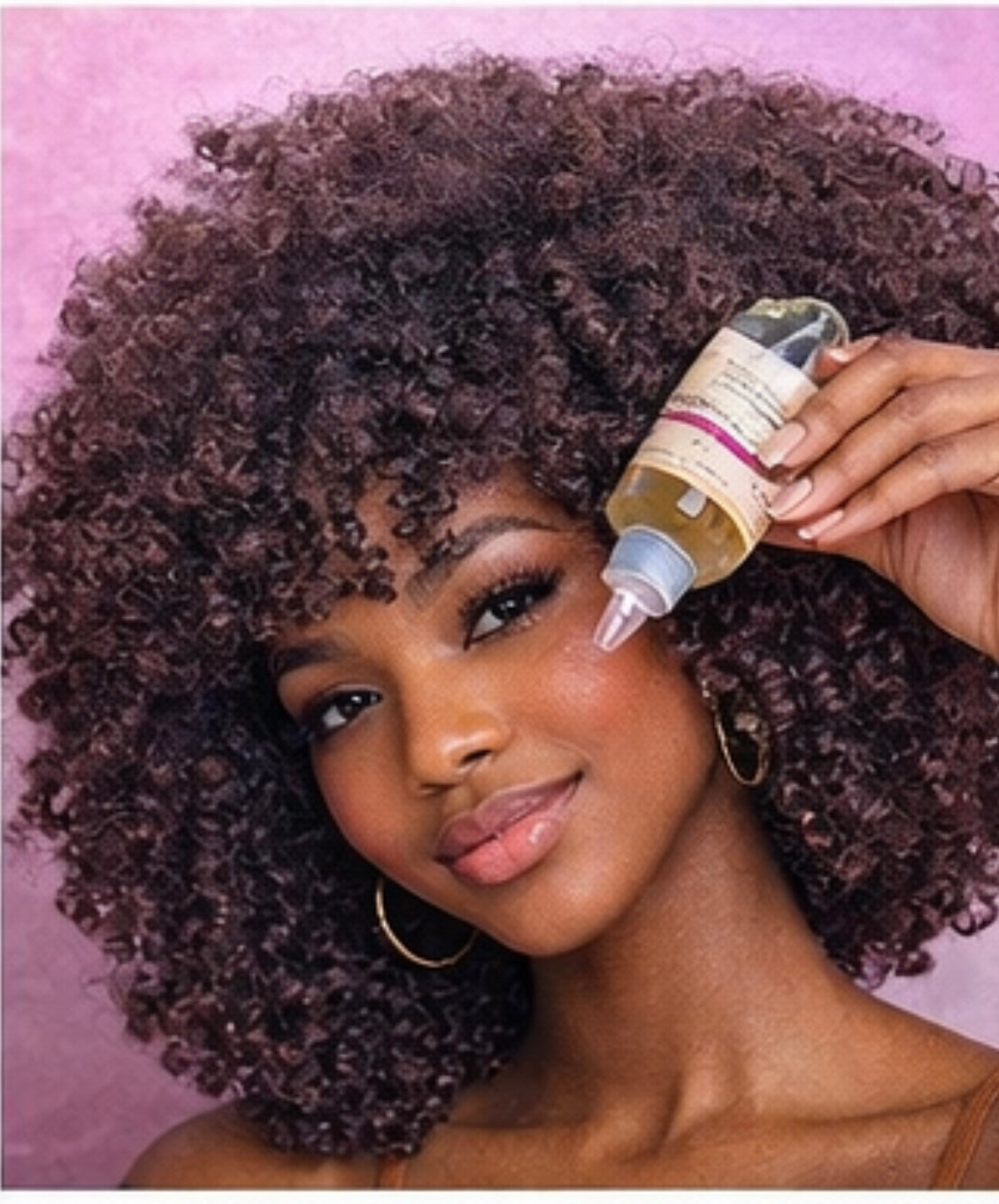 Butterbloom Hair Growth Oil with 21 herbs in a clear bottle, showcasing the rich, golden oil inside.