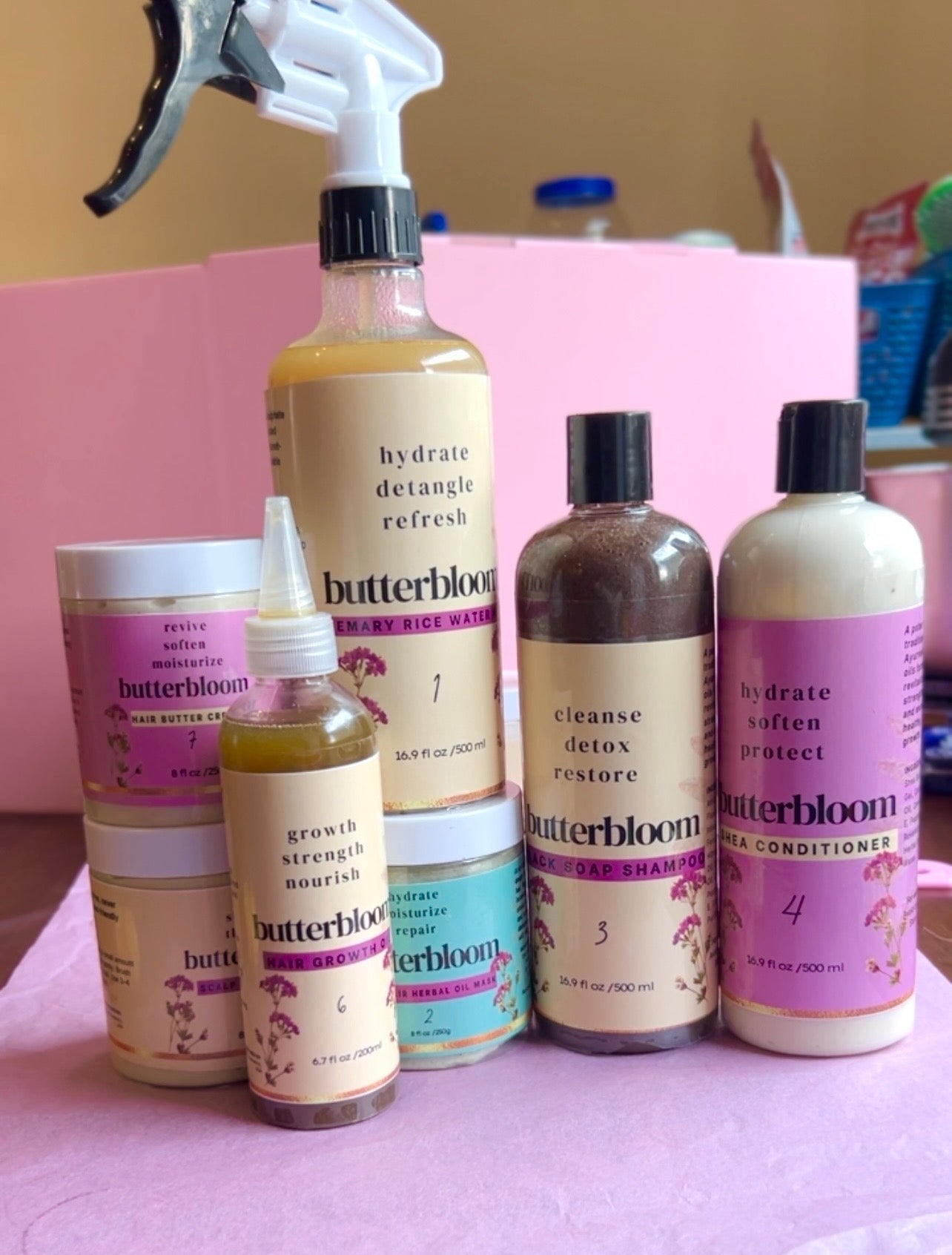 Hair Growth Bundle by butterbloom featuring shea butter, rice water, black soap shampoo, growth oil, and scalp stimulator.