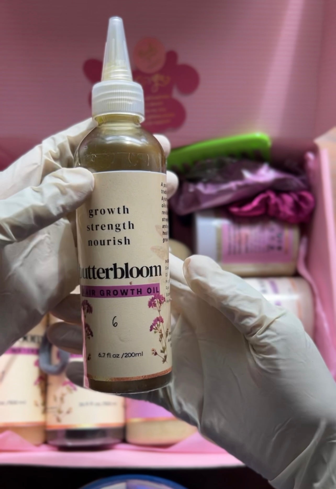 Butterbloom hair growth oil bottle with 21 herbs, showcasing its natural ingredients and sleek packaging.