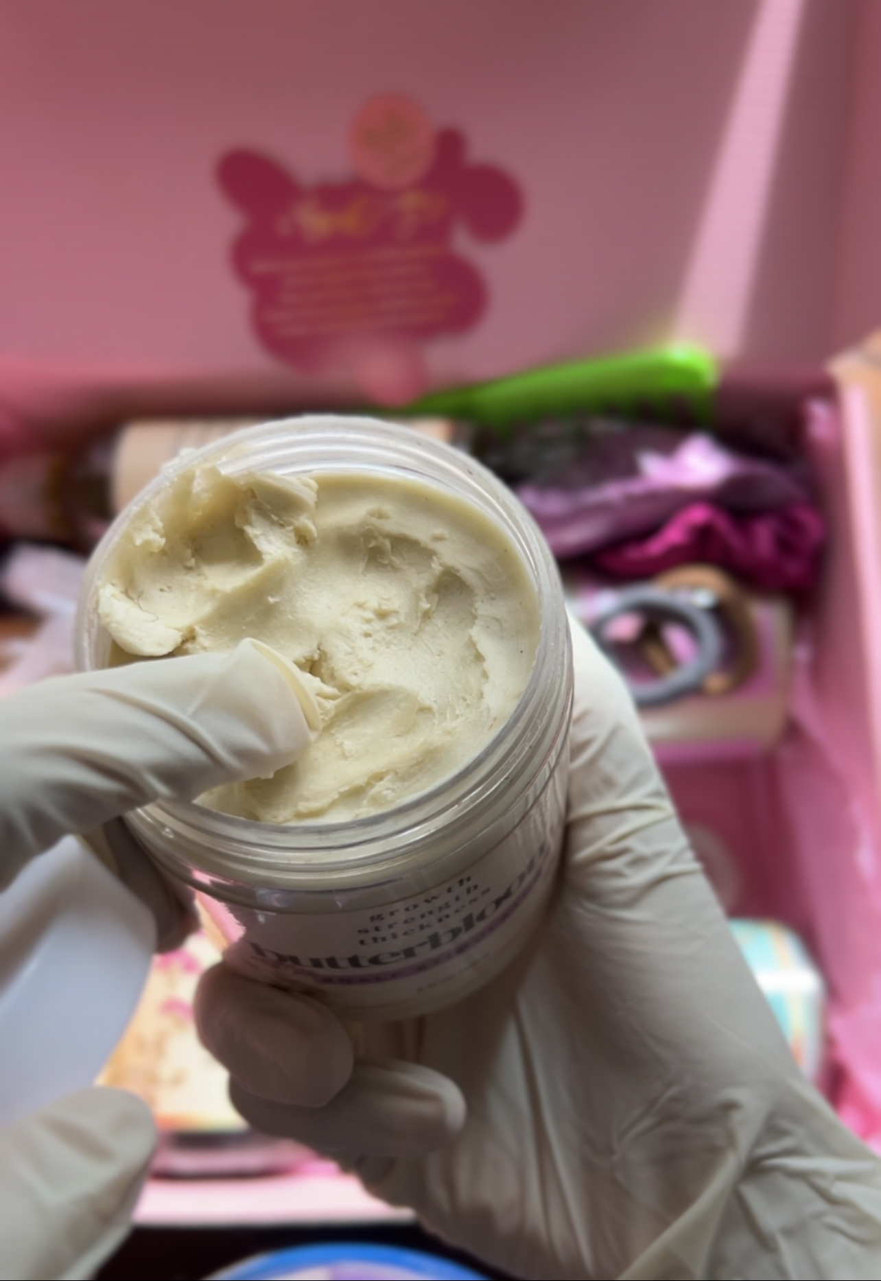 Butterbloom hair growth scalp stimulator balm in a jar with a smooth texture and herbal ingredients visible.