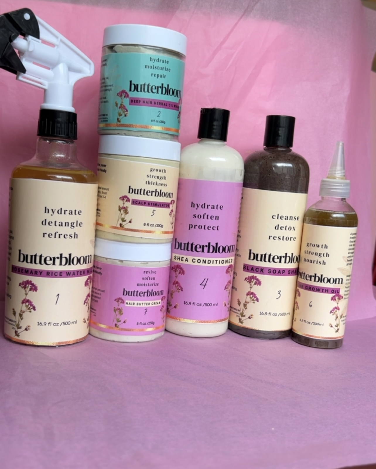 Hair Growth Bundle by butterbloom featuring shea butter, rice water, African black soap shampoo, growth oil, and scalp stimulator.