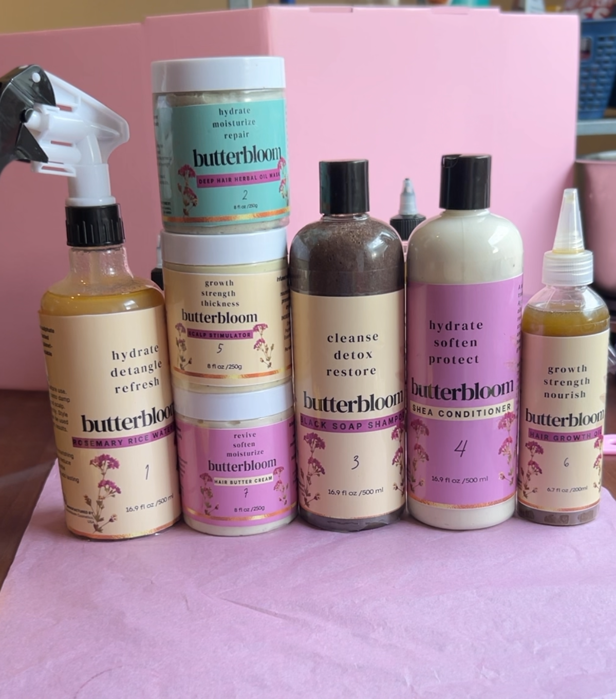 Hair Growth Bundle by butterbloom featuring shea butter, rice water, African black soap shampoo, growth oil, and scalp stimulator.